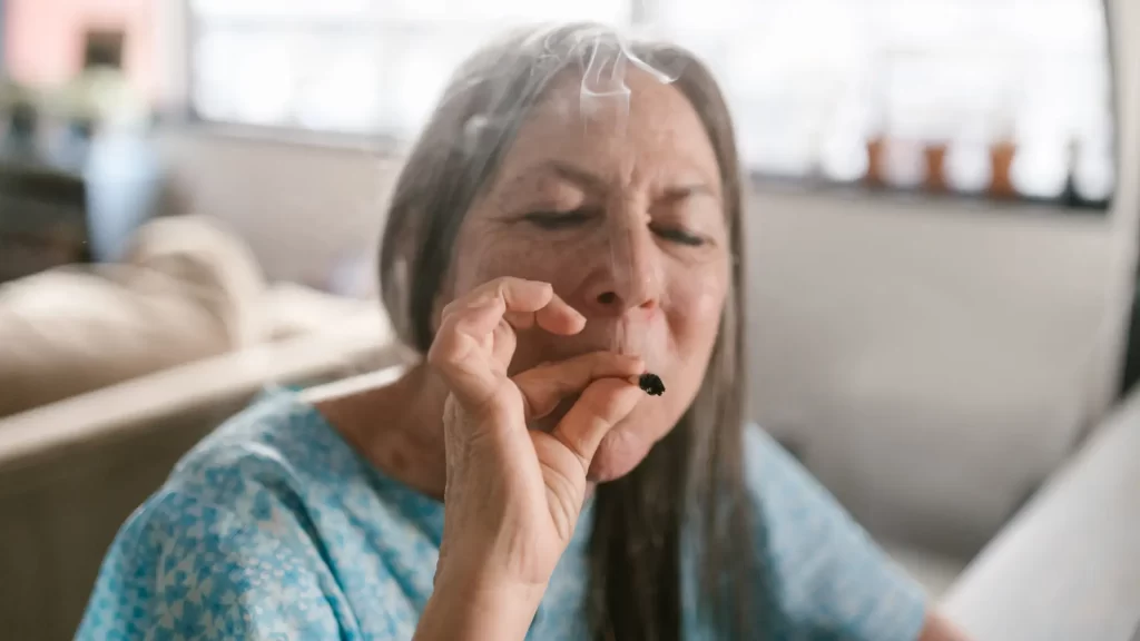 woman taking a hit of a marijuana joint