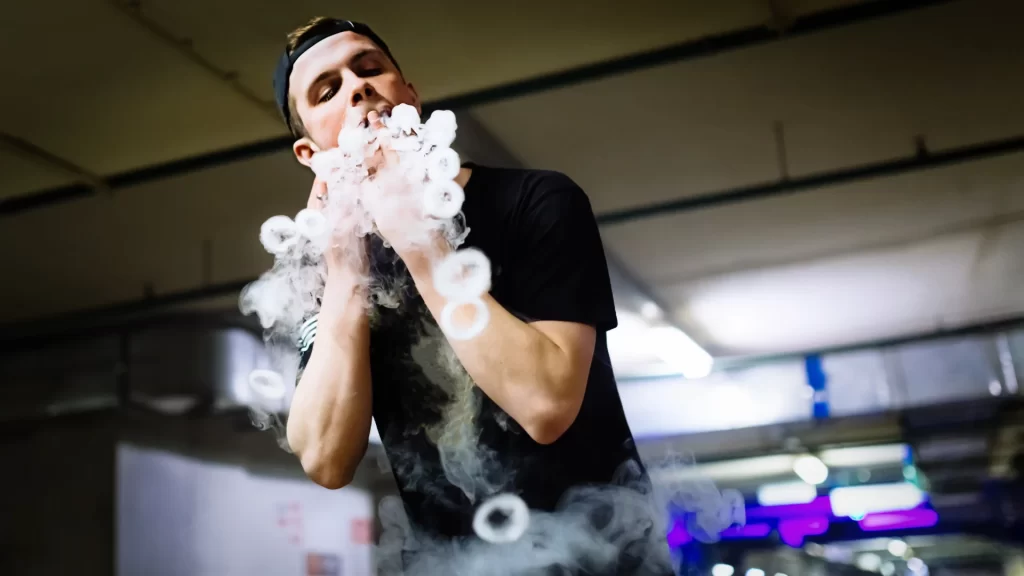a man performing smoke rings vape trick